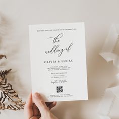 a person holding up a wedding card with the wording on it and gold foil