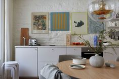 a dining room table with plates and vases on it