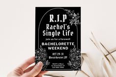 a person holding up a black and white ticket for a concert with the name rachel's single life on it