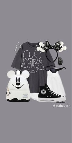 the mickey mouse outfit is on display in front of a gray background with black and white accessories