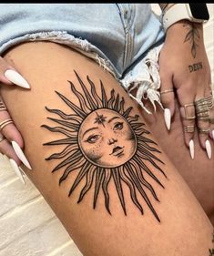 a woman's thigh with a sun tattoo on it