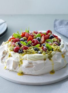 a cake with fruit on top sitting on a table