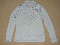 This listing is for a nice Nike gray w/ pink swoosh zip-neck pullover, womens size M (8-10).  There is a small spot toward the bottom of the front...so faint, though, that I didn't notice the first couple of times I looked over the shirt.  Might continue to lighten or disappear with treatment.  This pullover is in very good / pre-owned condition. Our home is smoke free and pet free, but many of our items are previously used and so I can't guarantee that the items have always been in a smoke free Our Home, The First, Athletic Jacket, Womens Sizes, Nike, Pet, Grey, 10 Things, Pink