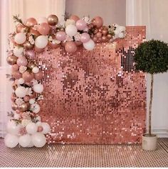 a rose gold sequin backdrop with balloons and flowers