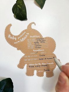 someone is cutting out some paper to make an elephant baby shower game for their little ones