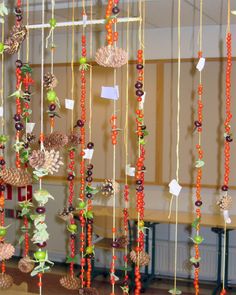 a wind chime with pine cones and beads hanging from it