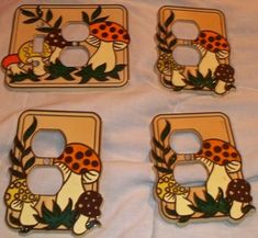 four decorative light switch covers with mushrooms and leaves on them