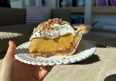 a slice of pumpkin pie on a paper plate