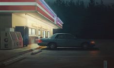 a car parked in front of a gas station at night