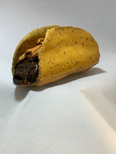 a half eaten banana sitting on top of a white table