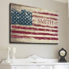 an american flag is hanging on the wall above a creden dresser in a white room