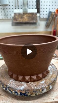 a clay bowl sitting on top of a table