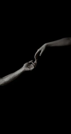 two hands reaching out towards each other in front of a black background with the word love written on it