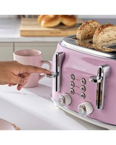 a pink toaster sitting on top of a white counter