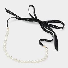 This traditional Ribbon Pearl Necklace exudes class and sophistication with its timeless design. The pearls are elegantly fastened with a declutter black ribbon, offering a refined touch to any ensemble. **Necklace:**- **Size:** 52" in length, allowing for versatile styling options- **Pearl Size:** 0.4" in length Additionally, the necklace is lead and nickel compliant, ensuring it is safe and comfortable to wear. Pearl And Ribbon Necklace, Formal Necklace, Formal Earrings, Formal Accessories, Ribbon Necklace, Pearl Jewelry Necklace, Necklace Size, Small Earrings, Black Ribbon