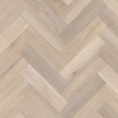 an image of wood flooring that looks like chevron herringbones in grey and white