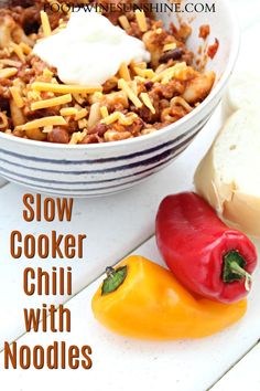 slow cooker chili with noodles in a bowl next to a hot dog