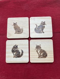 four wooden coasters with cats on them