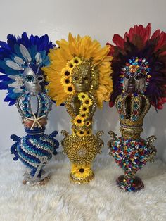 three vases with sunflowers and other decorative items