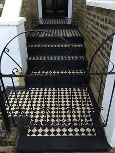 black and white tiled steps leading up to a door