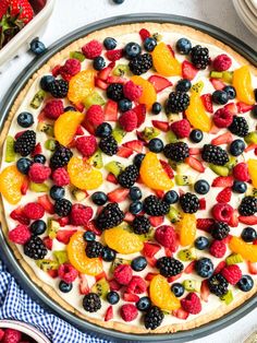 a pie with fruit on it sitting on top of a table