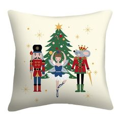 a pillow with nutcrackers and a christmas tree