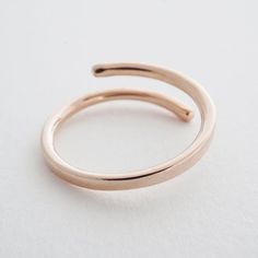 A polished, wrap-around band that makes a bold statement. Available in a hammered or smooth finish. 2 mm thick. Size: 6/7; slightly adjustable. Our materials make for an amazing, high quality, seamless, jewelry piece with longevity. Our rings are plated with 18k gold, 18k rose gold, or sterling silver and finished with a protective coating. A little secret we'll keep between us: it looks way more than it costs. Need help finding your ring size? See our printable ring size chart. Rose Gold Midi Ring With Open Band, Modern Rose Gold Midi Ring With Open Band, Modern Rose Gold Midi Rings For Formal Occasions, Printable Ring Size Chart, Wrap Around Ring, Delicate Gold Jewelry, Bow Jewelry, Between Us, Gold Heart Necklace