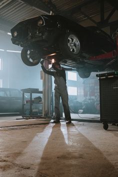 a man working on a car in a garage