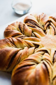 a large braided pastry sitting on top of a white counter