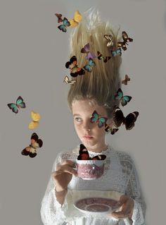 a woman holding a cup with butterflies flying around her