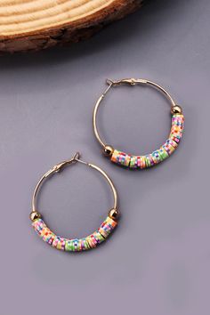 The colorful heishi beads are the highlight of this set of earrings. It with a simple and classic hoop earring design, So looks delicate and cute. It will make your outfit more eye-catching and add more fascination, vitality, Elegant and charming. DIMENSION length: 2"width: 2" earring back: Hingedmetal finish: Gold Platingproduct: Lead & Nickel Compliantanti-tarnish: Double E-coating Make Your Outfit, Jewelry Logo, Clay Bracelet, Sunglass Chain, Heishi Beads, Beaded Hoop Earrings, Beaded Hoops, Steel Necklace, Clay Beads