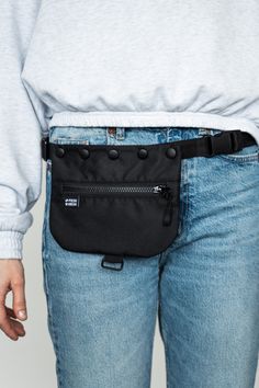 a person wearing a black fanny bag