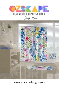 a bathroom with flowers on the shower curtain and bath rugs in front of it