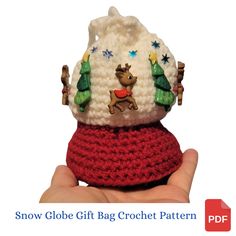 a small crocheted christmas ornament in the shape of a snow globe