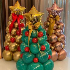 three christmas trees made out of balloons and gold stars