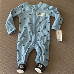 Brand New! Blue Baby Footie Pajamas. Light Blue With Dark Blue Football Pattern. 100% Cotton. Blue Cotton Onesie For Sleep, Blue Cotton Onesie For Loungewear, Blue Casual Onesie For Sleep, Light Blue Long Sleeve Cotton Onesie, Cotton Blue Onesie For Bedtime, Blue Long Sleeve Onesie For Sleepover, Playful Blue Onesie For Loungewear, Playful Blue Onesie For Sleepover, Light Blue Long Sleeve Onesie For Playtime