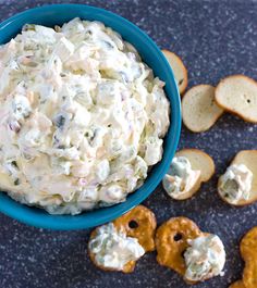 a blue bowl filled with food next to crackers