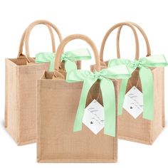 three jute bags with green bows and tags on the handles, tied in twine