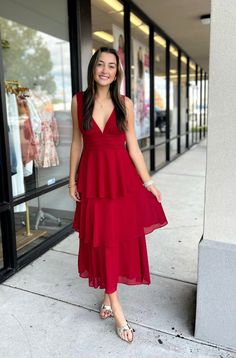 This dress is a statement of modern elegance. With its deep V-neckline in front and back, gathering detail and tiered bottom, it exudes luxury. Crafted from a deep red fabric with a fully lined interior, this beautiful dress is sure to turn heads. Perfect for an evening out or a special occasion. Material has no amount of stretch Medium measures: Bust 32" Length 52" 100% Polyester Layered Ruffle Dress, Little Red Dress, Luxury Dress, Red Fabric, Modern Elegance, Beautiful Dress, Deep Red, Ruffle Dress, Red Dress