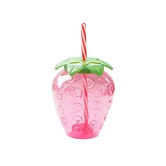 a pink glass vase with a candy cane sticking out of it's top, on a white background