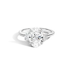 an oval diamond ring with three pear shaped diamonds