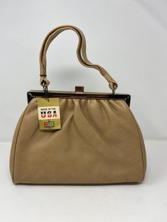 Vintage 70s Great American by Kmart soft silkie vinyl handbag in tan color. Deadstock with original tags 15" height x 14" wide Free shipping This is a vintage treasure! As always, This is one of my latest rare finds! I've been searching for 70's, 80's & 90's styled outfits sets in a good condition for a while. I was very surprised when I found this set in a mint condition!! About the outfit: - Mint condition - Unique and rare find. You will stand out with this set in a good and fashionable way! 70s Accessories Purse, Vintage Handbags From 70s, 70s Bags, Outfit Mint, Styled Outfits, Pretty Skirts, Tan Color, Vintage 70s, Purses And Handbags