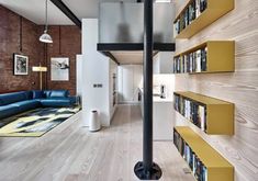 the interior of a modern home with bookshelves