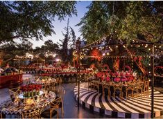 an outdoor event set up with tables and chairs, decorated in black and white stripes