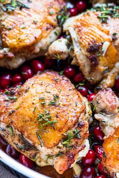 chicken thighs with cranberries and herbs in a white bowl