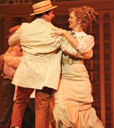 a man and woman dance together on stage