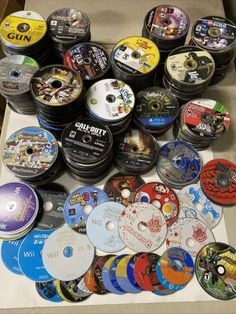 many different types of dvd's are on the table with each one being sold