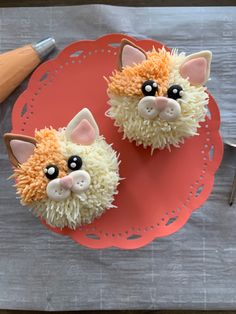 two cupcakes that have been made to look like cats