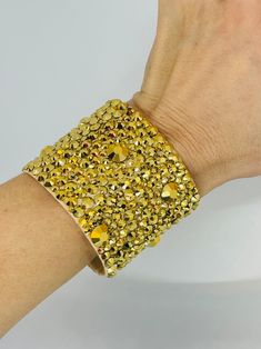 "This gorgeous 2\" Swarovski Crystal AB Rhinestone Cuff is a stunner! Designed with 12SS, 16SS, 20SS, and 40SS Crystal Aurum (gold) rhinestones. Guaranteed to sparkle and shine on and off the dance floor. Made with gold colored faux leather and closed by a hook and loop closure.  Outer dimensions are 7.5\" L x 2\"W and with interior dimensions (dimensions excluding hook and loop closure) are 6.75\" L x 2\"W. This cuff is will comfortably fit a 5.5\" to a 6.5\" wrist Note: Custom stone color on c Baguette Earring, Interior Dimensions, Crystal Ab, Gold Rhinestone, Shine On, The Dance, Drop Pendant, Dance Floor, Hook And Loop