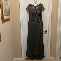 a black dress hanging on a door way